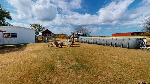 9497 Fm 804, Larue, TX 75770 - view of green lawn featuring an outdoor pool and a playground