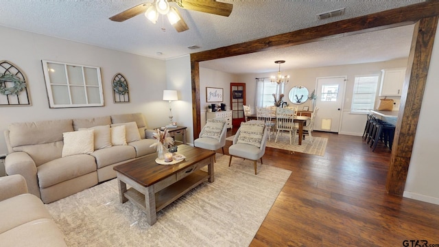 living room featuring a textured ceiling, ceiling fan with notable chandelier, dark hardwood / wood-style floors, and beam ceiling