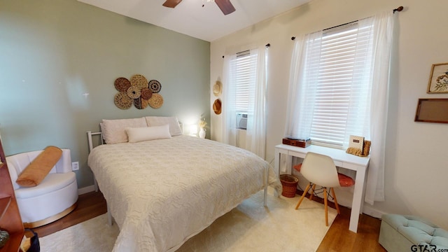 bedroom with ceiling fan and light hardwood / wood-style floors