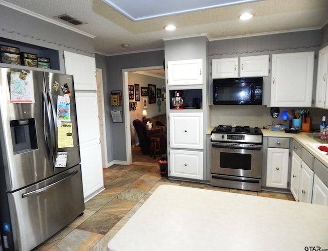 kitchen featuring stainless steel appliances, white cabinets, a textured ceiling, and ornamental molding