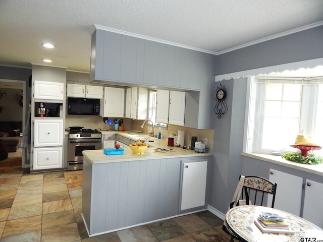 kitchen with ornamental molding, white cabinetry, sink, stainless steel range, and kitchen peninsula