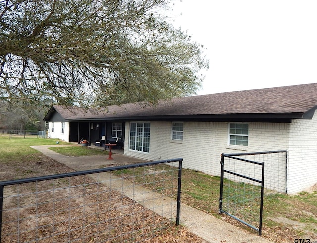 rear view of property featuring a lawn