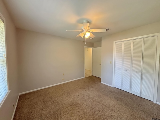 unfurnished bedroom featuring a closet, baseboards, and carpet