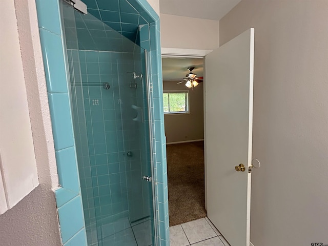full bathroom with a shower stall, a ceiling fan, tile patterned flooring, and baseboards