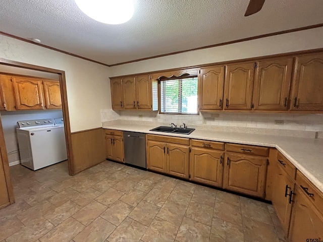 kitchen featuring a sink, brown cabinetry, stainless steel dishwasher, and a textured ceiling