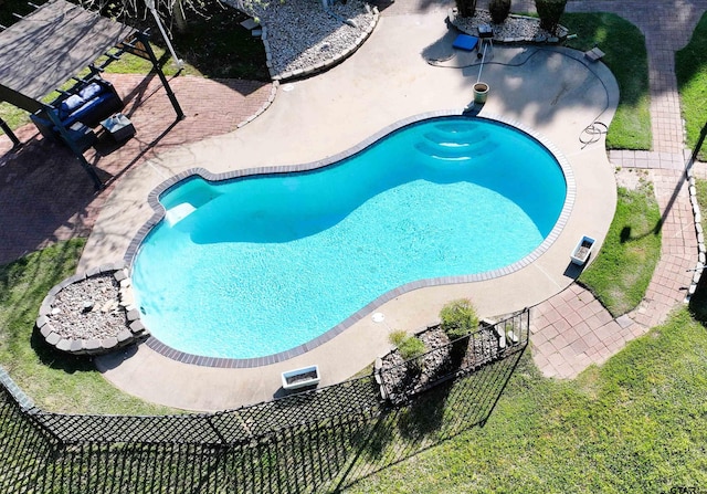 view of swimming pool featuring a patio area and fence