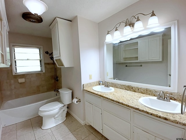 full bath featuring toilet, double vanity, a sink, and tile patterned flooring
