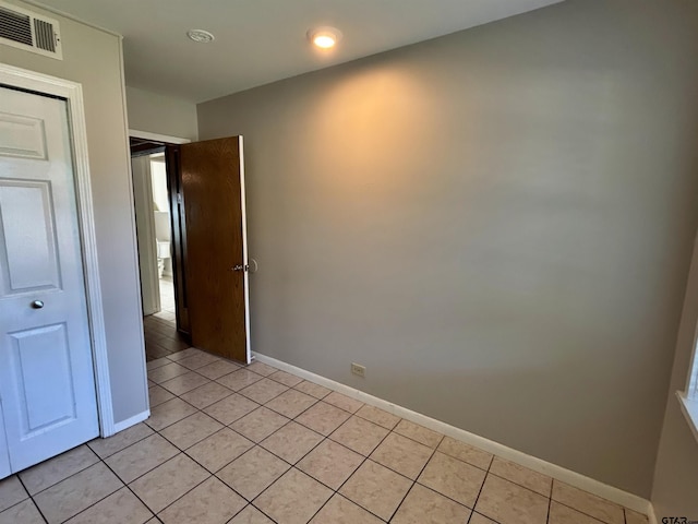 empty room with visible vents, baseboards, recessed lighting, and light tile patterned floors