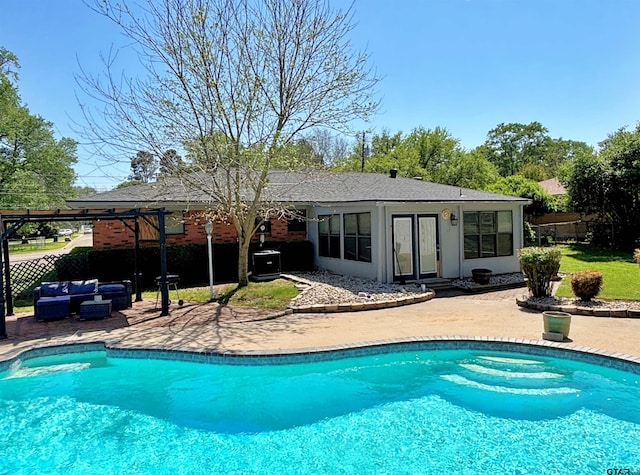 outdoor pool featuring a patio, an outdoor hangout area, and fence