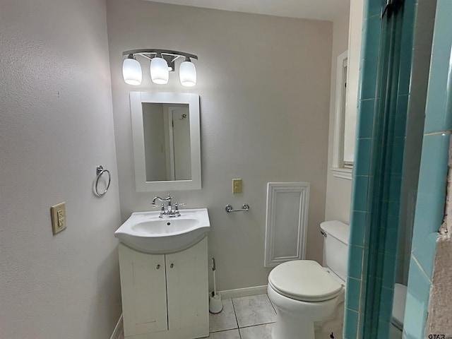 bathroom with vanity, baseboards, tile patterned flooring, toilet, and a shower with shower door
