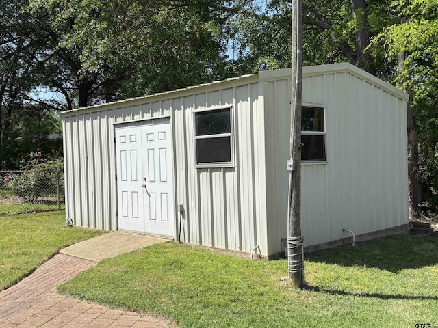 view of shed featuring fence