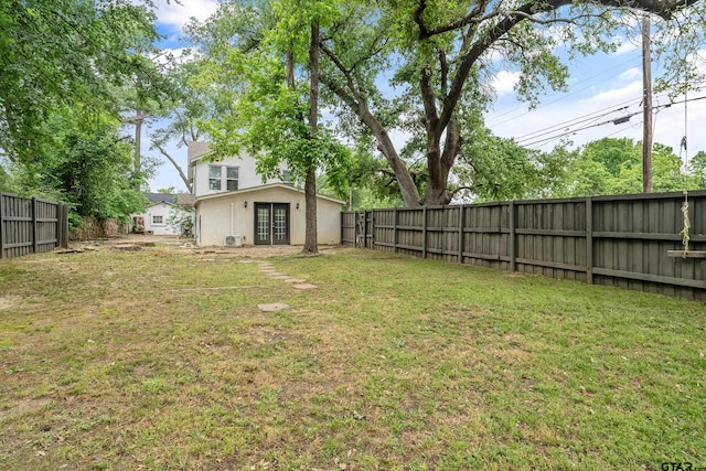 view of yard with french doors and a fenced backyard