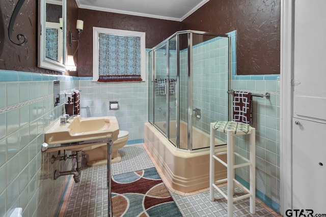 full bathroom featuring toilet, tile patterned floors, crown molding, and enclosed tub / shower combo