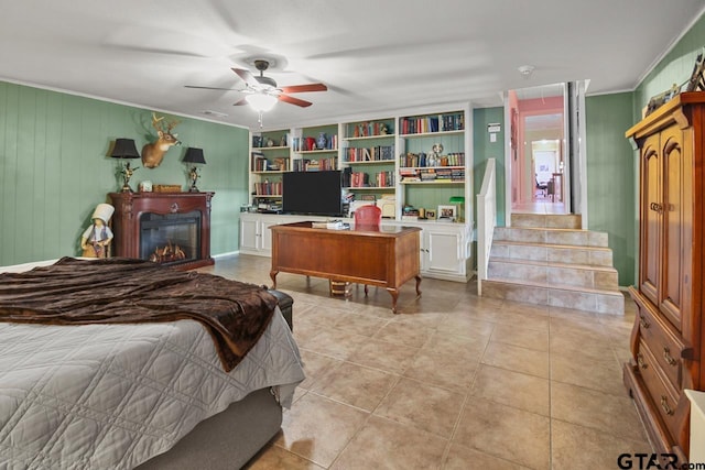 bedroom featuring light tile patterned floors, ceiling fan, and ornamental molding