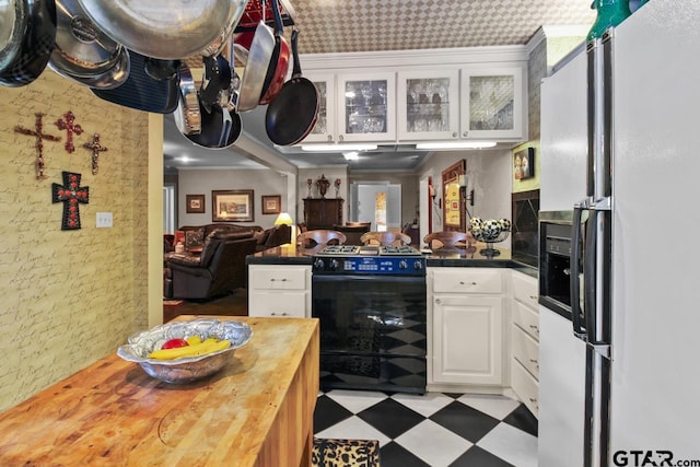 kitchen with white cabinetry, black electric range oven, white refrigerator with ice dispenser, and wood counters