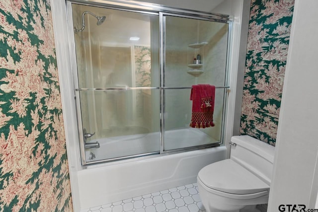 bathroom featuring shower / bath combination with glass door and toilet