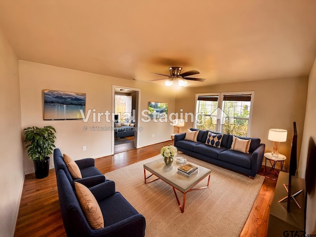 living room with wood-type flooring and ceiling fan