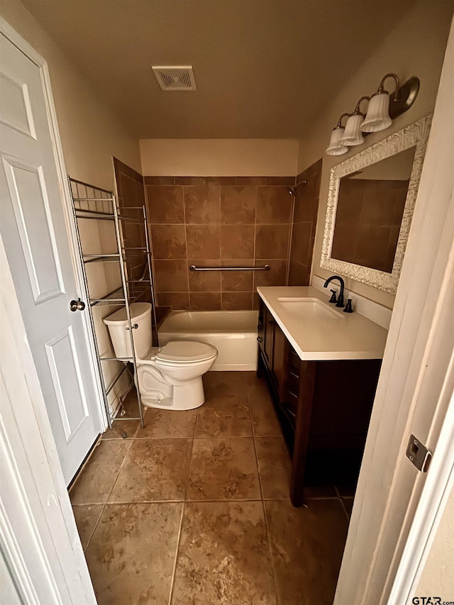 full bathroom featuring vanity, tiled shower / bath, tile patterned floors, and toilet