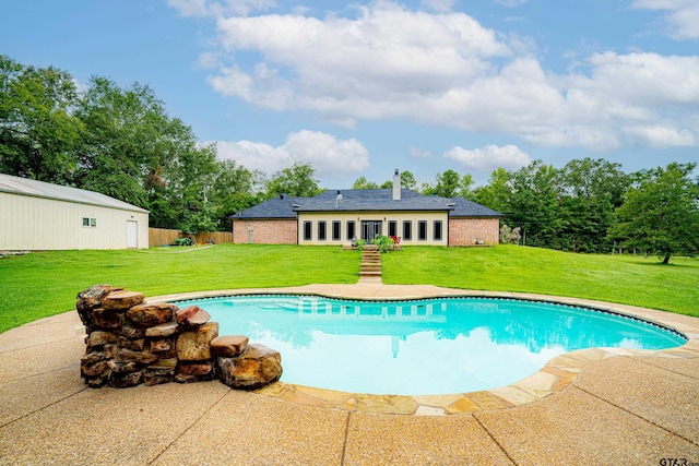 view of swimming pool with a lawn and a patio