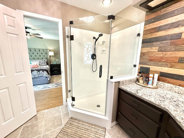 18872 Big Timber Rd, Tyler, TX 75703 - full bathroom with ensuite bath, a stall shower, tile patterned floors, wood walls, and vanity
