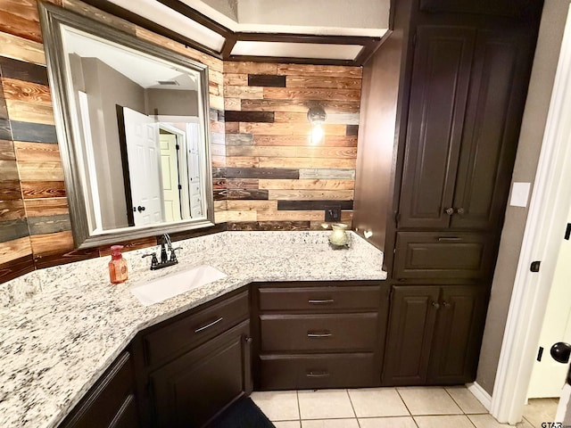 18872 Big Timber Rd, Tyler, TX 75703 - bathroom with tile patterned floors, wooden walls, and vanity