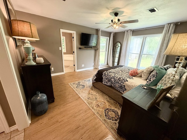 18872 Big Timber Rd, Tyler, TX 75703 - bedroom with light wood-type flooring, a ceiling fan, and ensuite bathroom