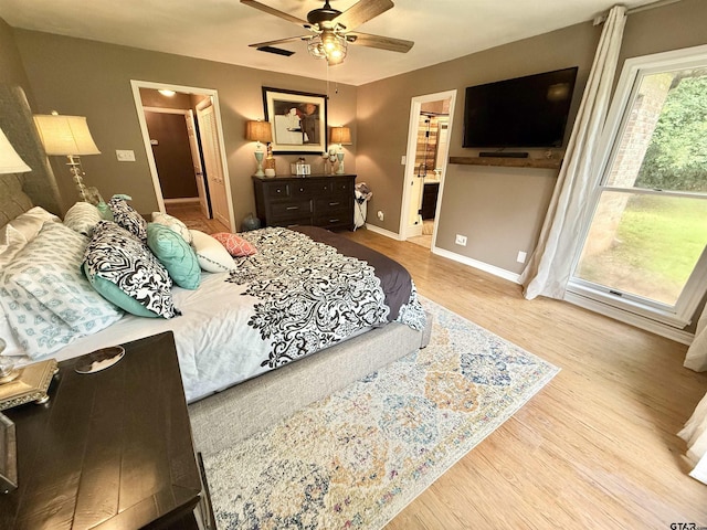 18872 Big Timber Rd, Tyler, TX 75703 - bedroom with wood finished floors, connected bathroom, and a ceiling fan