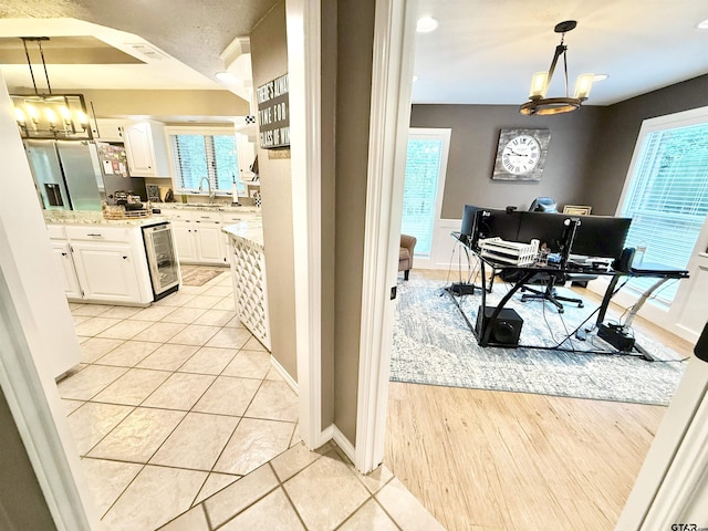 18872 Big Timber Rd, Tyler, TX 75703 - kitchen with a chandelier, white cabinets, an office area, stainless steel refrigerator with ice dispenser, and recessed lighting