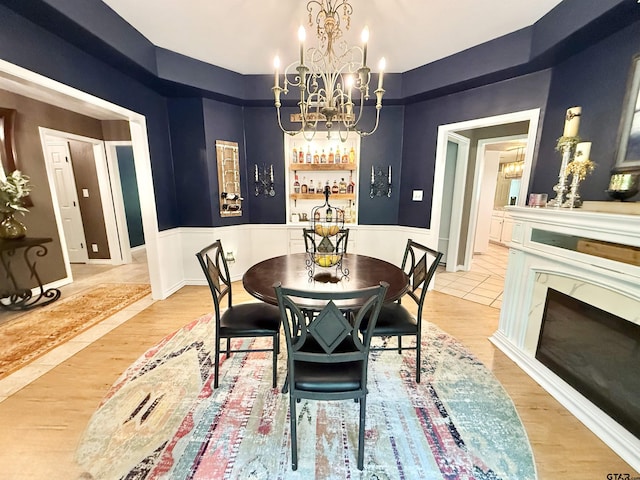 18872 Big Timber Rd, Tyler, TX 75703 - dining room featuring a chandelier, light wood finished floors, and a high end fireplace