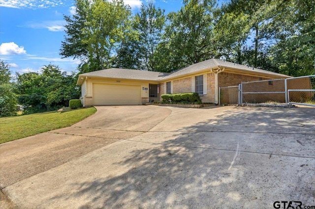 3121 S Robertson Ave, Tyler, TX 75701 - single story home with a gate, concrete driveway, brick siding, and a garage