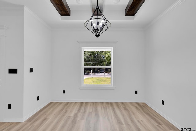 interior space with light wood-type flooring, a notable chandelier, crown molding, and a tray ceiling