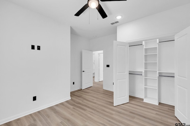 unfurnished bedroom with ceiling fan, a closet, and light wood-type flooring