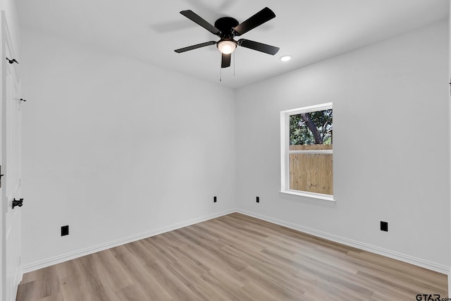 spare room with light hardwood / wood-style floors and ceiling fan