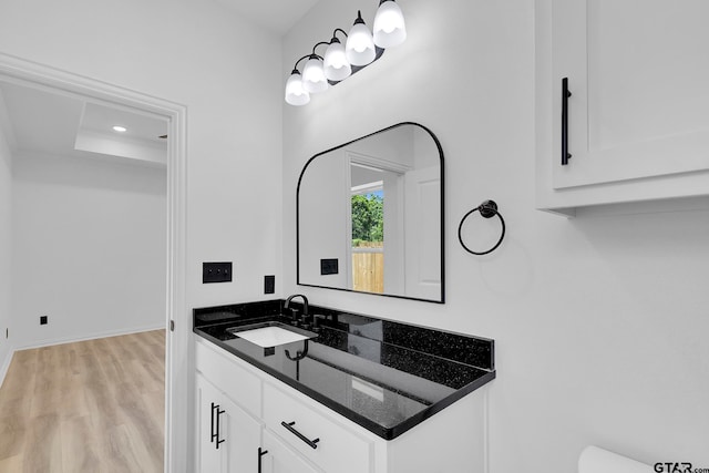 bathroom with vanity and hardwood / wood-style flooring