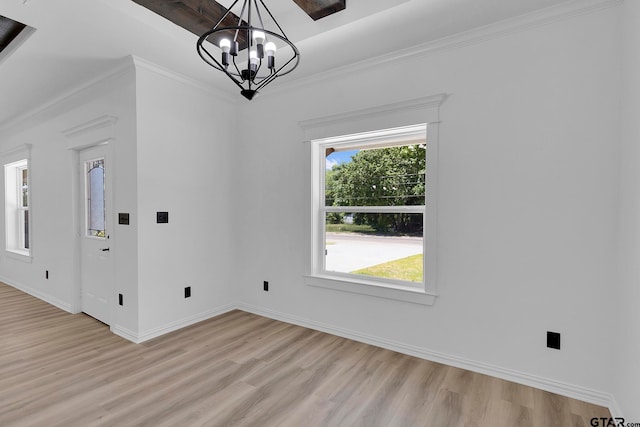 interior space with light hardwood / wood-style flooring, a notable chandelier, and crown molding