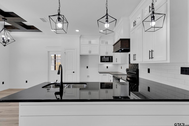 kitchen featuring sink, hanging light fixtures, stainless steel electric stove, black microwave, and premium range hood