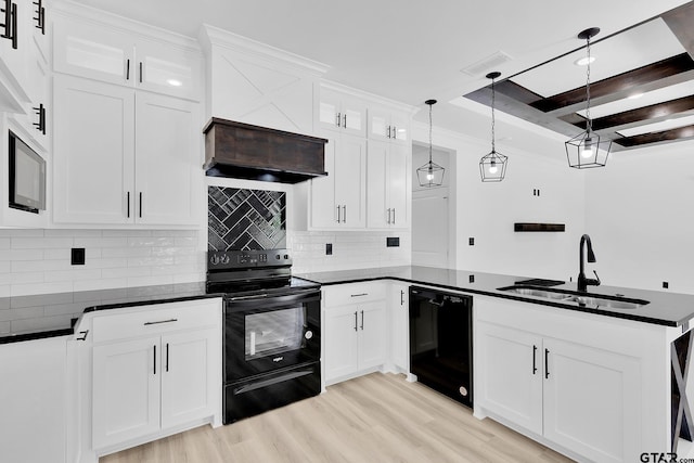 kitchen with white cabinetry, black appliances, sink, and decorative light fixtures