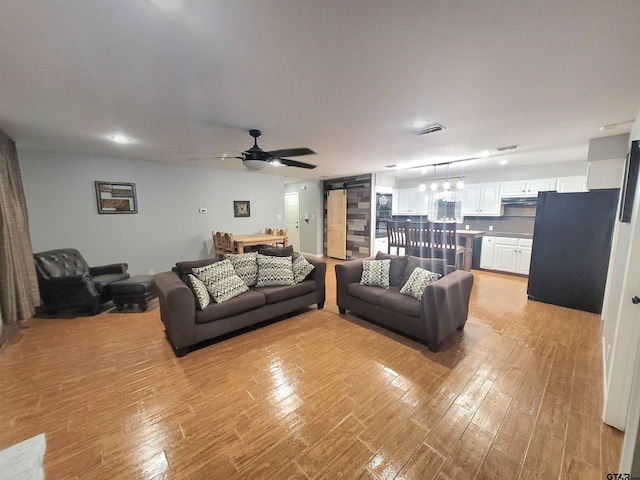 living room with visible vents, a ceiling fan, light wood-style floors, and recessed lighting