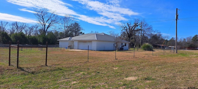 view of yard with fence and a garage