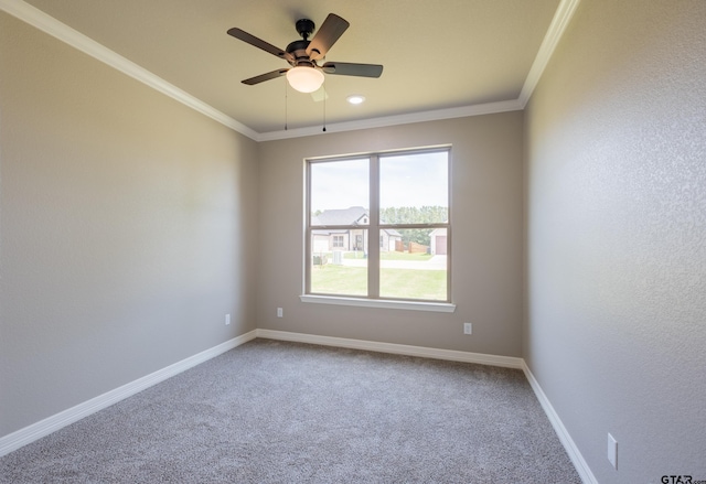 unfurnished room with crown molding, carpet floors, baseboards, and a ceiling fan
