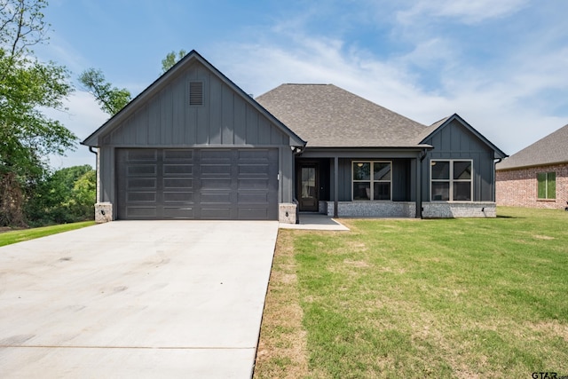 view of front facade with board and batten siding, roof with shingles, a front yard, an attached garage, and driveway