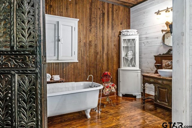 bathroom featuring wood ceiling, a bathing tub, wooden walls, and wood-type flooring