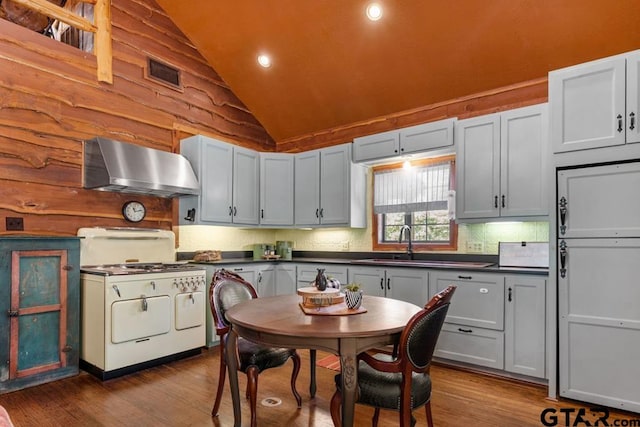 kitchen featuring hardwood / wood-style floors, white range, vaulted ceiling, range hood, and white cabinetry