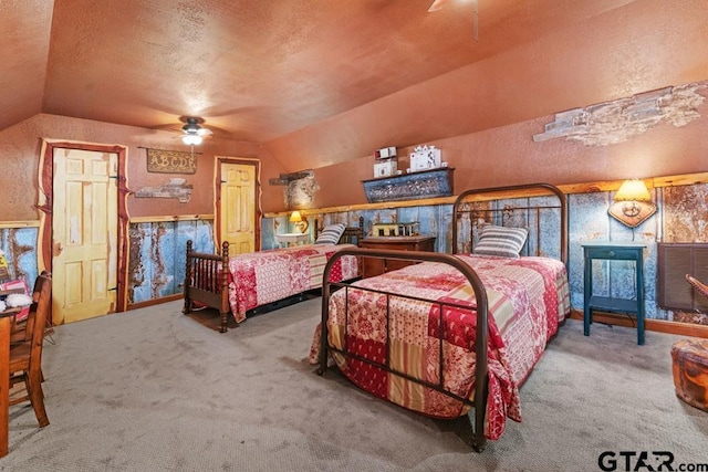 bedroom with ceiling fan, lofted ceiling, and a textured ceiling