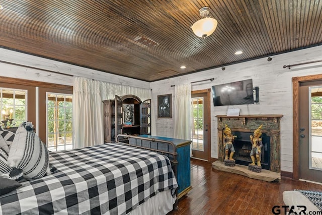 bedroom with access to exterior, dark hardwood / wood-style flooring, a fireplace, and wood ceiling