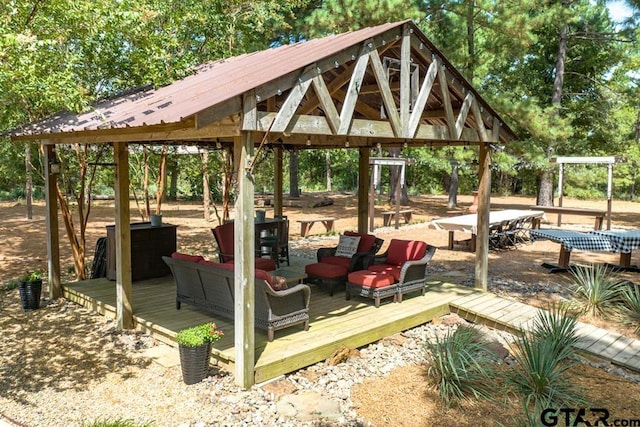 view of property's community with a gazebo, outdoor lounge area, and a deck