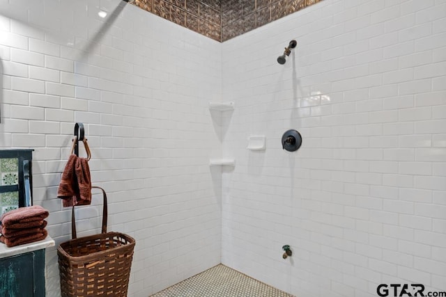 bathroom with tiled shower