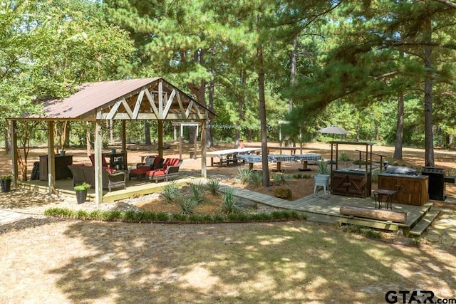 surrounding community featuring a gazebo, an outdoor living space, and area for grilling