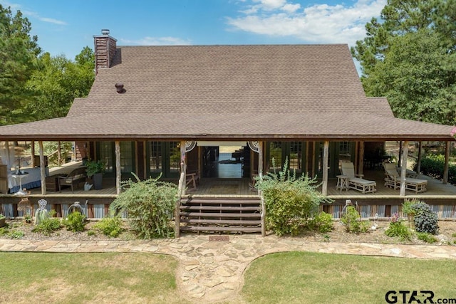 rear view of house featuring covered porch