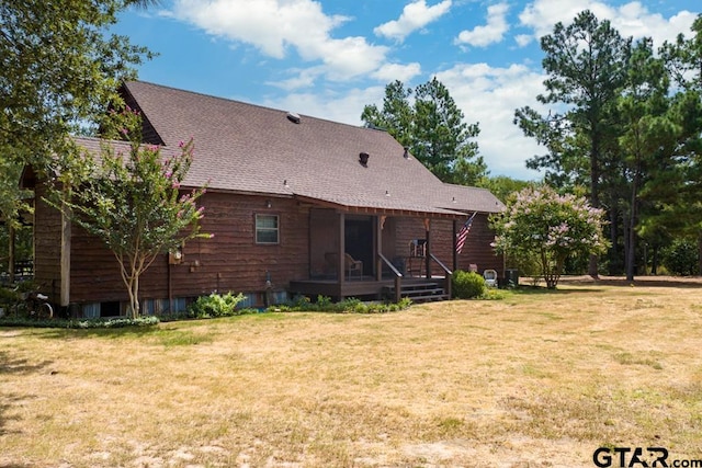 rear view of house with a lawn